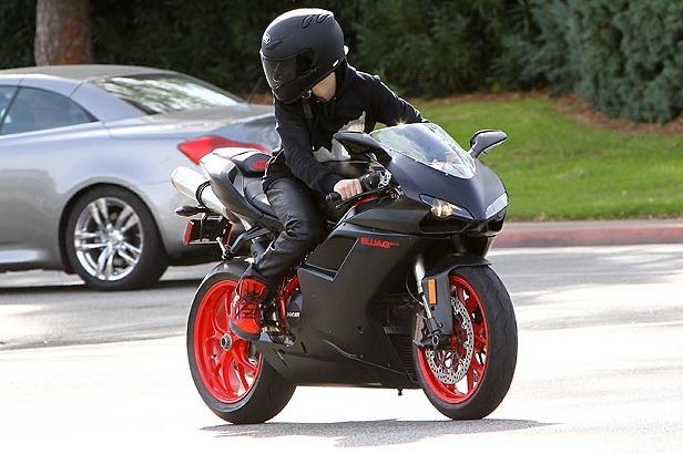 Justin Bieber driving in a matte black Ducati motorbike